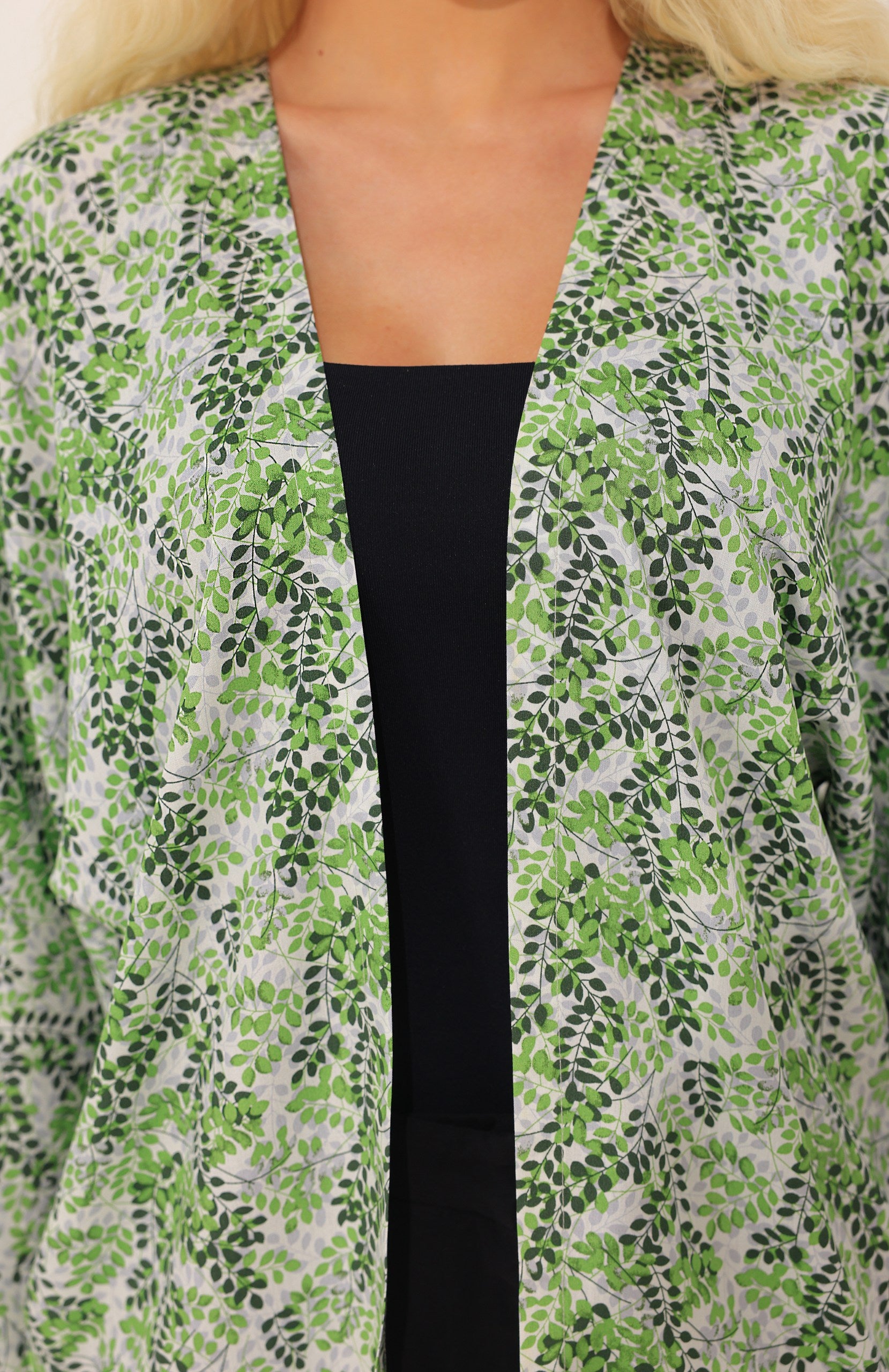 Person wearing a green floral kimono cover up inspired by Greece