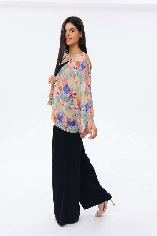 Woman wearing a colorful kimono and black pants on a white background