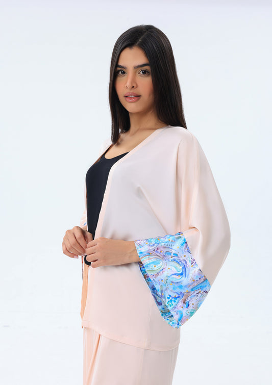 Woman wearing a modest cover up against a white background